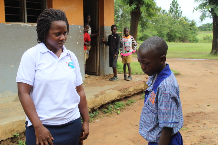 Lea talking with a school boy at Makembo Primary School FlowReady outreach