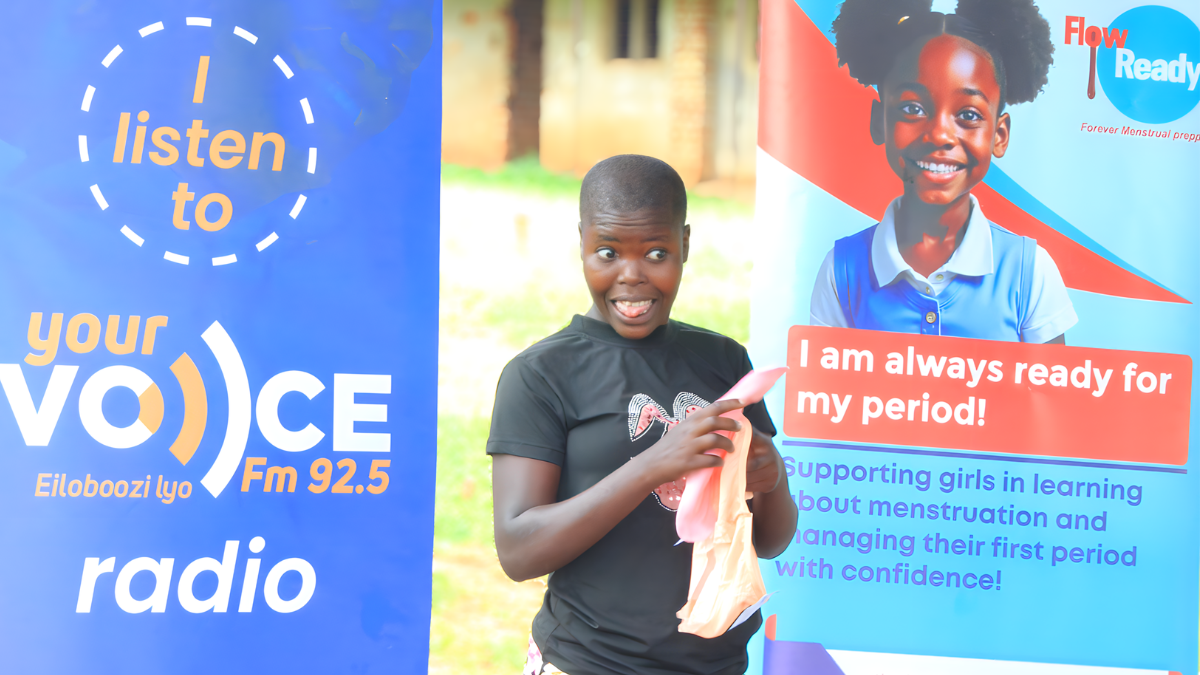 Young girl displaying a pad at a FlowReady outreach